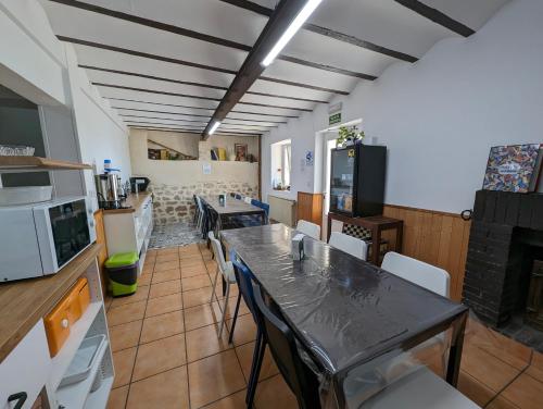 a kitchen and dining room with a table and chairs at Albergue El Alfar/Pilgrim Hostel in Hornillos del Camino
