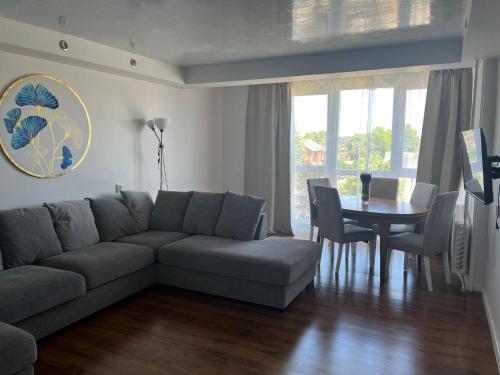 a living room with a couch and a table at Apartmentai Baltoji Ramune in Palanga