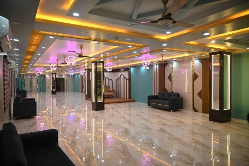a room with a lobby with couches and lights at PS Luxury Hotel in Baharampur