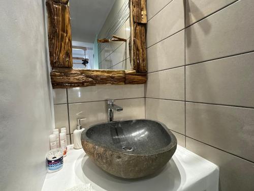 a bathroom with a large stone sink on a counter at Janakos Luxury Apartment in Glinado Naxos