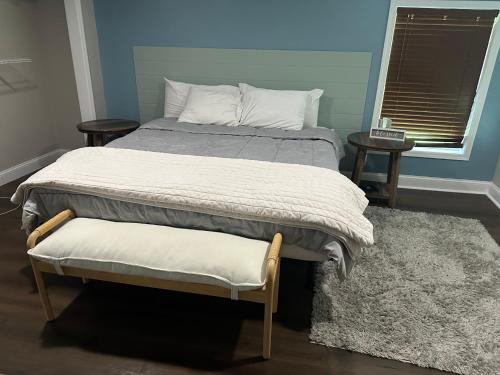 a bedroom with a bed and two tables and a window at Serenity away from the big city in Amelia