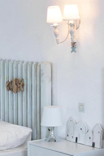 a lamp on a night stand next to a radiator at Brunis Apartments in Nei Poroi