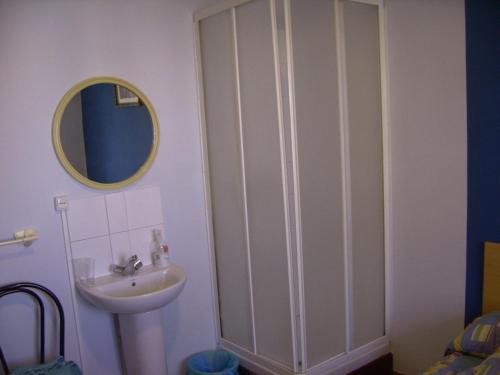 a bathroom with a sink and a mirror at Pensión Gema in Irún