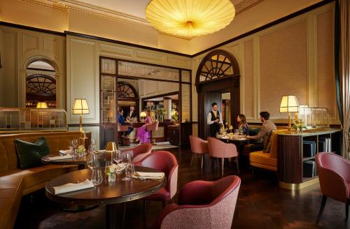 a restaurant with tables and chairs and people eating at Great Southern Killarney in Killarney