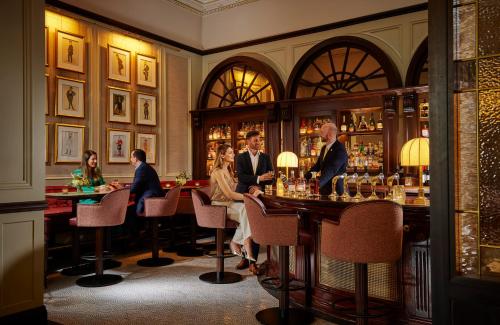 a group of people sitting at a bar at Great Southern Killarney in Killarney