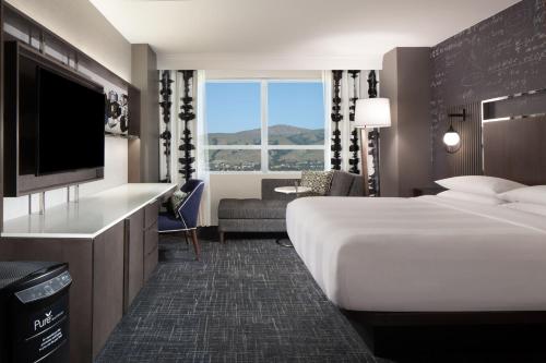 a hotel room with a bed and a television at Fremont Marriott Silicon Valley in Fremont