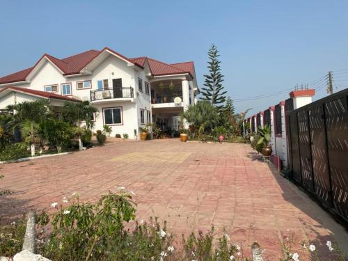 a brick driveway in front of a house at Haven Villa in Apowa