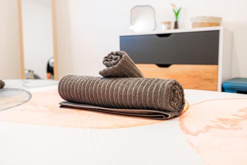 a stack of blankets on a bed at COZY Apartment In Kapparis #2 in Paralimni