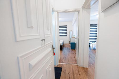 a hallway with a door leading to a bedroom at COZY Apartment In Kapparis #2 in Paralimni