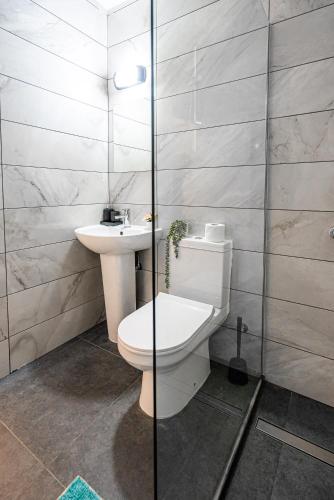 a bathroom with a toilet and a sink at COZY Apartment In Kapparis #2 in Paralimni