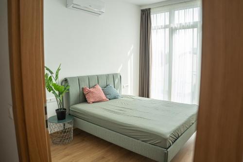 a bed with two pillows on it in a bedroom at DIAMOND Luxury Apartments in Siófok