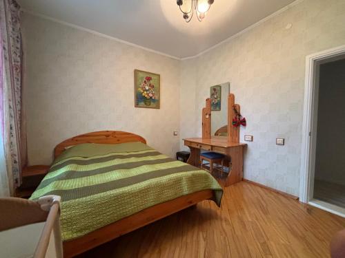 a bedroom with a bed and a table in it at Peaceful summer house - Sunshine in Jūrmala