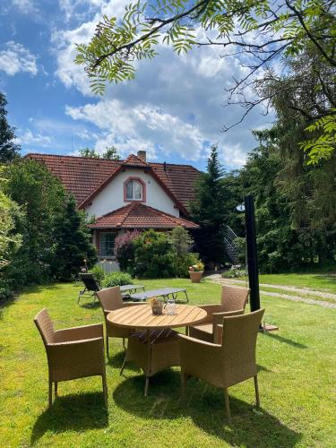 a table and chairs in the yard of a house at Vila EVIO Třeboň in Třeboň