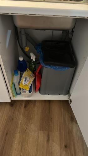 a cabinet filled with food and other items under a desk at Schöne Ferienwohnung in Schottwien