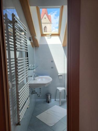 a bathroom with a sink and a window at Gasthaus Alpenflora in Auna di Sopra