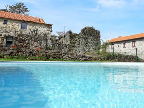 ein altes Steingebäude und ein Pool in der Unterkunft One bedroom house with shared pool enclosed garden and wifi at Agueda in Urgueira