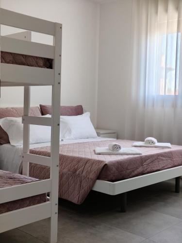 a bedroom with two bunk beds and a window at HappyKids bb Venice in Campalto