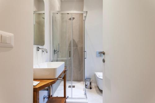 a bathroom with a sink and a shower at Youhosty - Ticinese Suite 4 in Milan