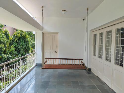 a hallway with a bench on a balcony at Fouzdar House by LuxUnlock Private Villas in Ahmedabad