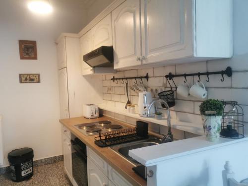a kitchen with white cabinets and a sink at Kúria Apartman Budapest with free parking in Budapest
