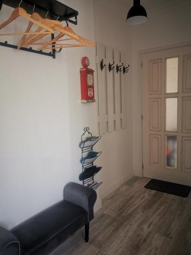a room with a black couch and a clock on the wall at Kúria Apartman Budapest with free parking in Budapest