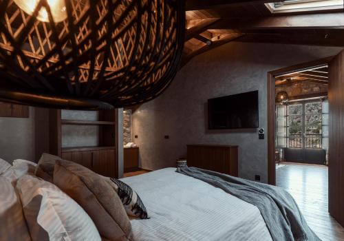 a bedroom with a large bed and a television at KaSeas Boutique Hotel in Gerolimenas