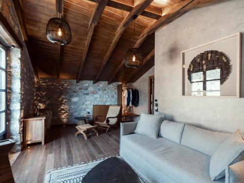 a living room with a couch and a table at KaSeas Boutique Hotel in Gerolimenas