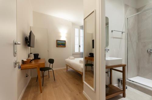 a bathroom with a shower and a sink and a desk at Youhosty - Ticinese Suite 3 in Milan