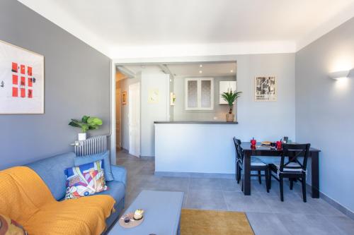 un salon avec un canapé bleu et une table dans l'établissement L12 Port window 1Bedroom Wifi 5mins beach & Nice's Cap, à Nice