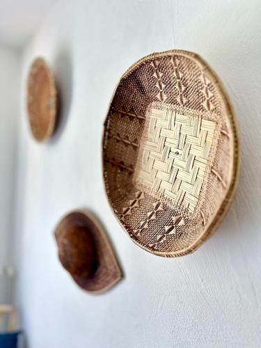 a copper object on a white wall with two knobs at Casa sardine in Cassis