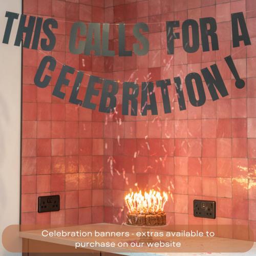 a sign that says this calls for a celebration with a fire at The Mini Stylish Getaway in Corsley