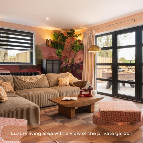 a living room with a view of the private garden at The Mini Stylish Getaway in Corsley