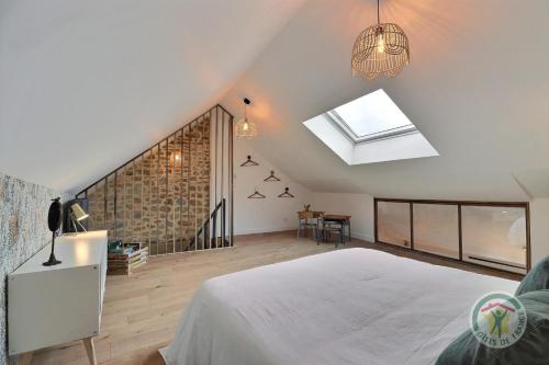 a bedroom with a white bed and a window at Victor in Saint-Georges-de-Chesné