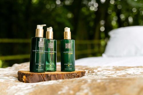 a group of three green bottles sitting on a table at Dunadry Hotel And Gardens in Antrim