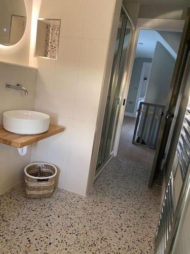 a bathroom with a sink and a walk in shower at An Riasc Farmhouse Rental in Dingle