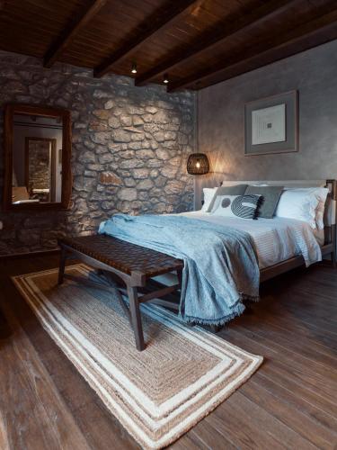a bedroom with a bed and a table in it at KaSeas Boutique Hotel in Gerolimenas