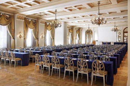a large banquet hall with blue tables and chairs at Hotel Grande Bretagne, a Luxury Collection Hotel, Athens in Athens