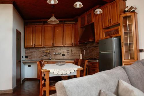 a kitchen with a table and a refrigerator at Old Bazaar House in Krujë
