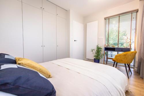 Ένα ή περισσότερα κρεβάτια σε δωμάτιο στο Navigare Apartments