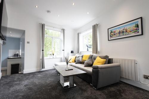 a living room with a couch and a table at Modern Boutique Studios in Central Bolton Perfect for Contractors & Short Stays in Bolton