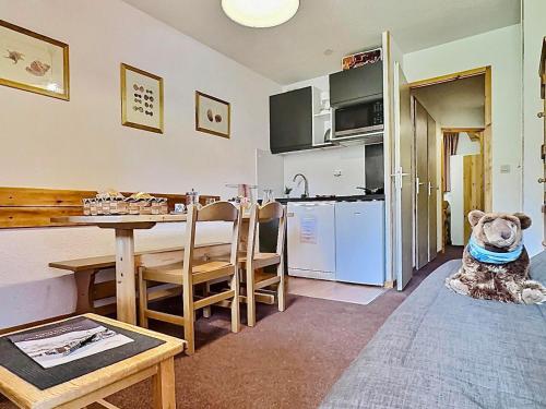 une pièce avec une cuisine et une table avec un animal en peluche dans l'établissement Studio 4 pers. à Tignes au pied des pistes, balcon et animaux acceptés - FR-1-411-391, à Tignes