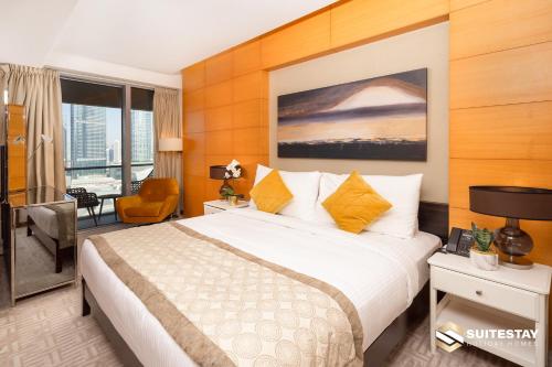 a hotel room with a large bed and a desk at Deluxe Stay - Address Dubai Mall -The Residence in Dubai