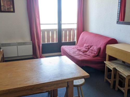 un salon avec un canapé rouge et une table dans l'établissement Appartement 2 pièces au pied des pistes avec balcon - FR-1-557-83, à Les Adrets