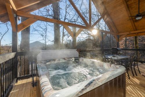 a hot tub on the deck of a cabin at Beautiful Vista by Eden Crest in Pigeon Forge