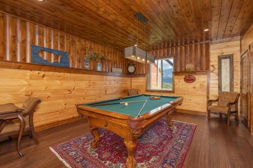 a pool table in a room with wooden walls at A Plus Amazing Views by Eden Crest in Gatlinburg