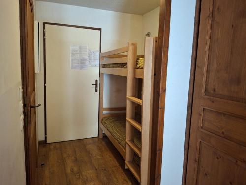 - un couloir avec des lits superposés et une porte menant à une chambre dans l'établissement Studio confortable avec balcon à Brides-les-Bains, pour 4 pers, proche thermes et centre-village - FR-1-512-271, à Brides-les-Bains