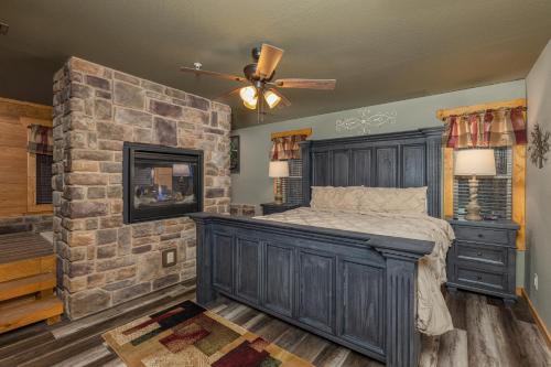 a bedroom with a large bed and a stone wall at Beautiful Vista by Eden Crest in Pigeon Forge
