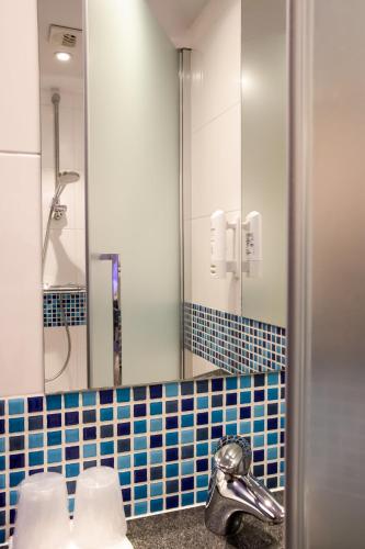 a bathroom with a sink and a mirror at Holiday Inn Express Toulouse Airport by IHG in Blagnac