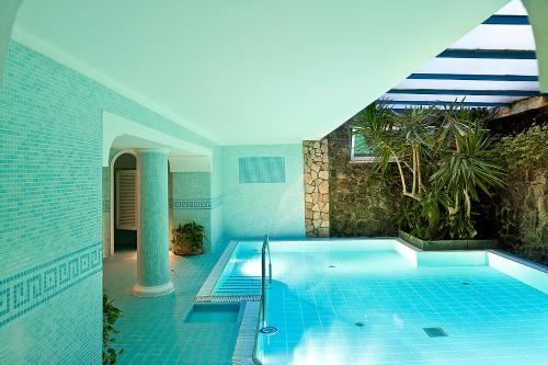 a swimming pool in the middle of a house at Grand Hotel Il Moresco in Ischia