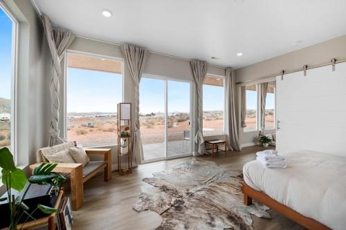a bedroom with a bed and a large window at Canyon Mesa Haven, Luxury Stay near Lake Powell in Big Water